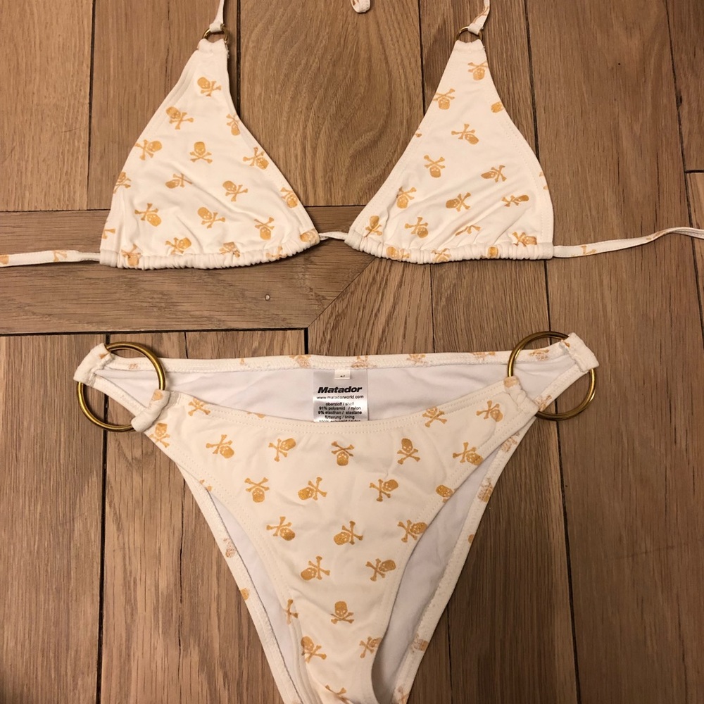 Like new Ivory with gold skulls bikini.